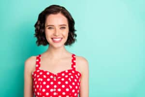 Close uap portrait of fascinating young, beautiful wonderful lady posing in front of came while isolated with teal background